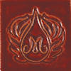 Glossy red ceramic tile featuring an intricate embossed design with a central letter M surrounded by stylized patterns.