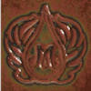Textured clay tile featuring a decorative design with a central motif and surrounding leaf patterns, ideal for ceramic projects.