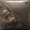 Ceramic tile with a textured brown surface, featuring intricate carvings and a glossy glaze finish, suitable for pottery projects.