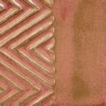 Textured clay surface featuring a zigzag pattern on the left and a smooth, warm-toned area on the right, ideal for ceramics.