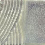 Textured ceramic glaze sample showcasing a glossy, speckled surface with wavy and smooth areas, ideal for pottery decoration.