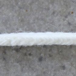 White cotton cord laid flat on a textured surface, suitable for binding ceramic projects and studio supplies.