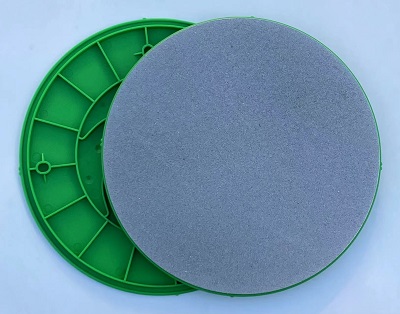Green pottery reclaim tray with a smooth gray surface, ideal for clay preparation and reducing waste in ceramic studios.