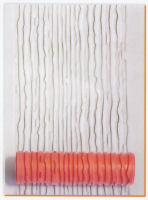 Textured white clay with a ribbed orange roller used for creating patterns in pottery or ceramic decoration techniques.