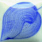 Blue ceramic glaze displaying intricate swirls and patterns on a white clay background, ideal for pottery decoration.