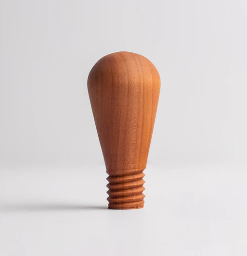 Wooden pottery tool with a rounded top and threaded base, used for shaping and detailing clay in ceramics.