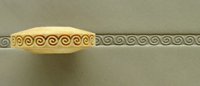 Ceramic ribbon with a spiral design and a textured clay surface in a ceramic studio setting.