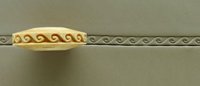 Decorative yellow clay trim with swirl pattern, positioned above a textured gray ceramic strip, showcasing pottery design techniques.