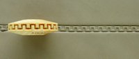 Detail of a ceramic texture roller with zigzag pattern, used for decorating pottery and clay surfaces.