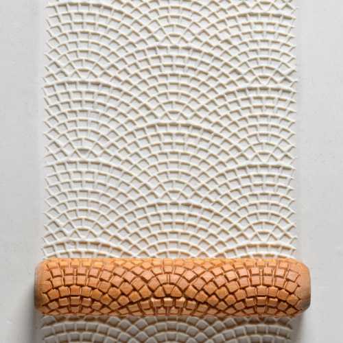 Textured clay rolled with a patterned slab roller, showcasing an intricate design for ceramic projects at Georgies Ceramic & Clay Company.