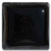 Glossy black ceramic glaze sample in a square dish, ideal for pottery decoration and kiln firing applications.