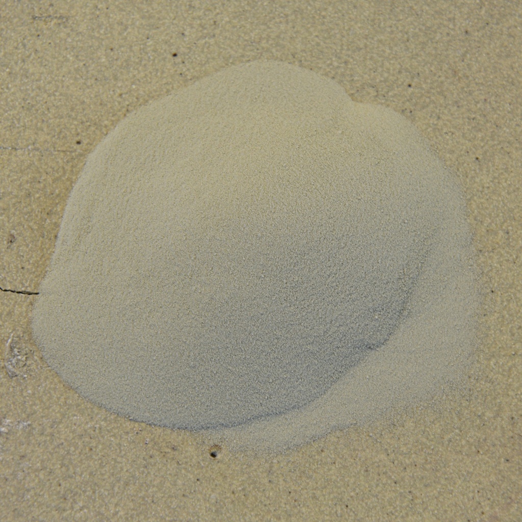 A mound of pale clay powder sits on a flat surface, showcasing the fine texture ideal for pottery and ceramic sculpture.