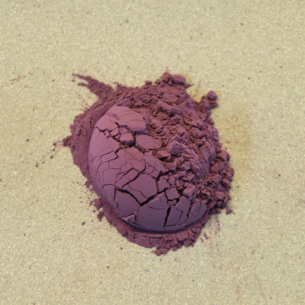 Purple ceramic underglaze pigment crumbled on a smooth surface, ideal for decorating pottery and sculpture.