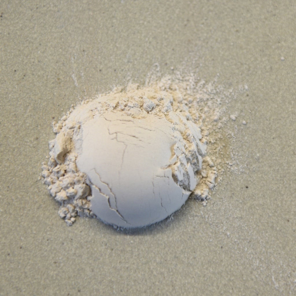 Dry ball of white clay on a smooth surface, ready for pottery or sculpture applications at Georgies Ceramic & Clay Company.