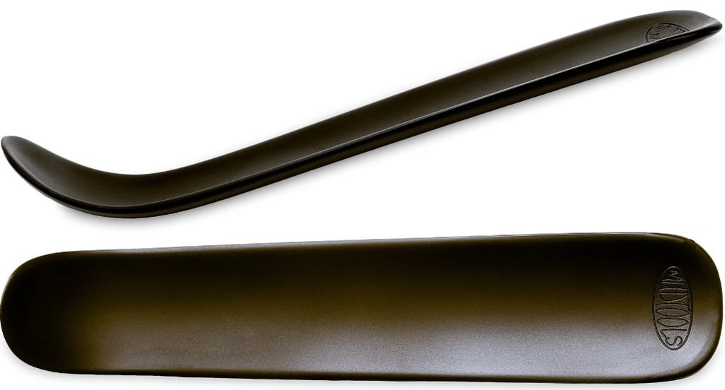 Black ceramic rib tool with curved and flat edges, ideal for smoothing clay surfaces in pottery and sculpture work.