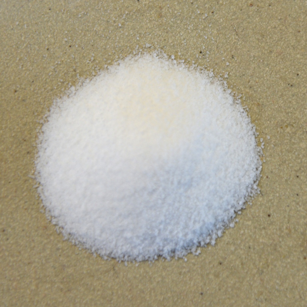 White powder, likely a ceramic material or glaze ingredient, on a textured surface, suitable for pottery and ceramic practices.