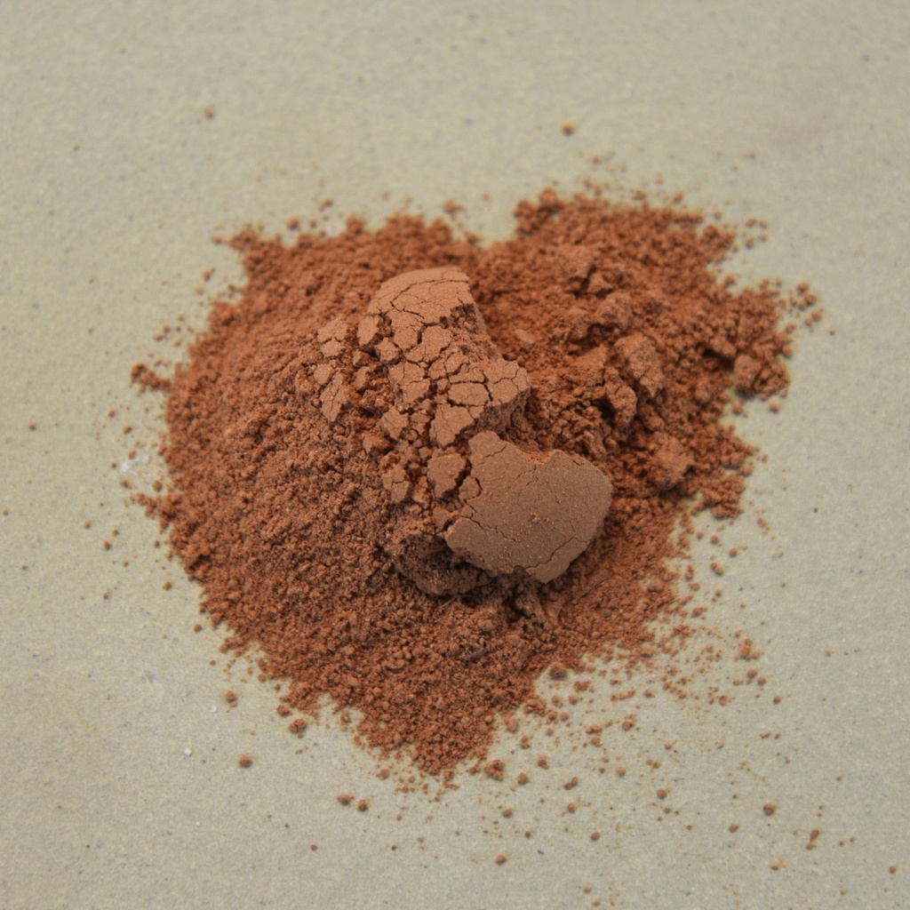 Red iron oxide powder on a neutral surface, commonly used for ceramic glazes and clay body coloring at Georgies Ceramic & Clay Company.
