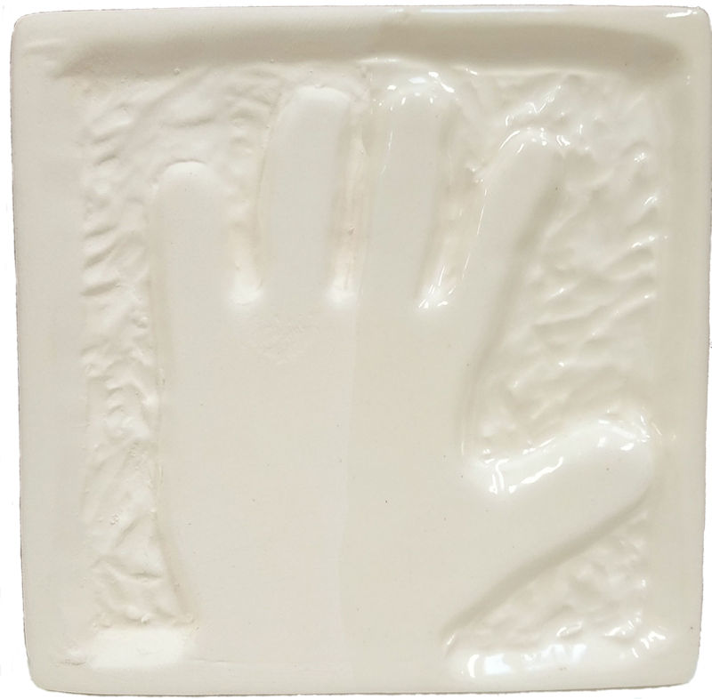 Hand-shaped impression on a white ceramic tile, showcasing texture and relief for decorative or educational purposes.