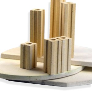 Various unglazed ceramic forms and a circular bat for pottery displayed on a white background, showcasing raw clay textures.